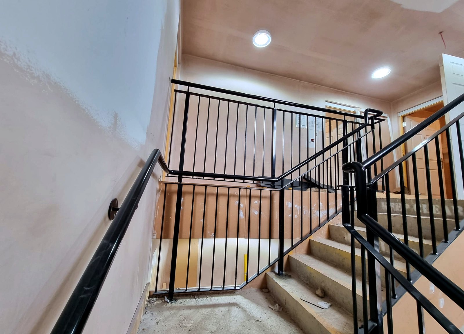 Custom steel communal staircase balustrade on a live apartment build, Radlett